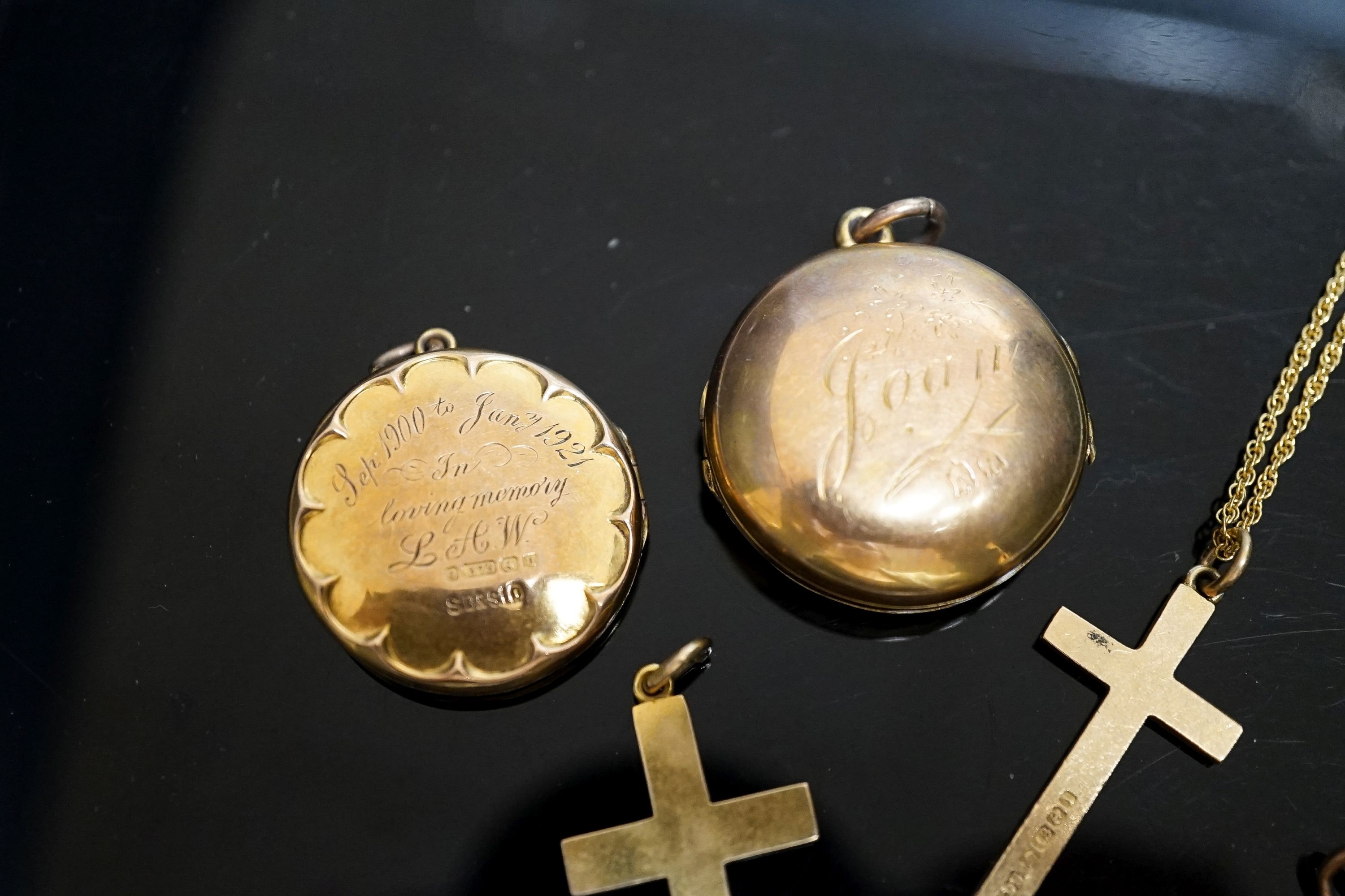 A group of small lockets and an 18ct cross pendant, 3.2 grams and a 15ct cross pendant, 3.6 grams.